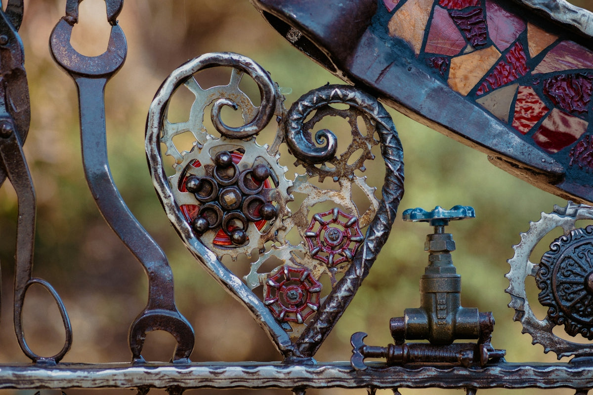 a close up of a metal fence with a heart