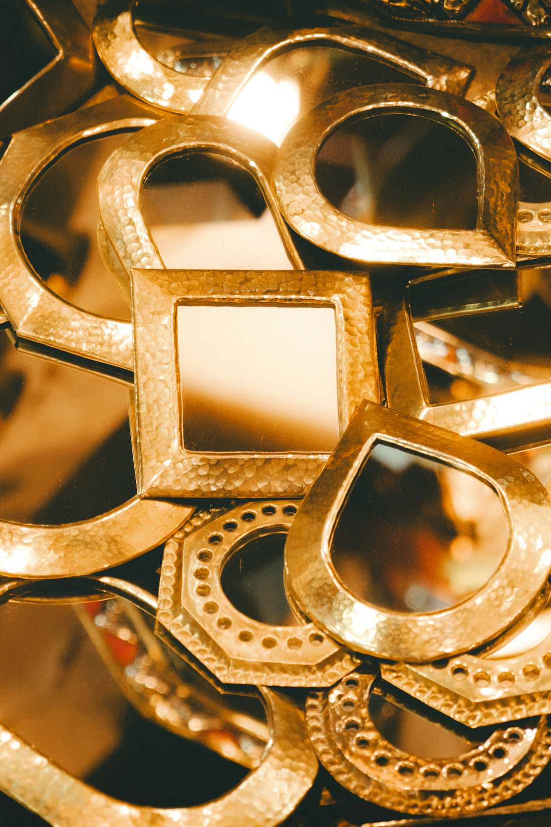Assortment of golden decorative mirrors in various shapes