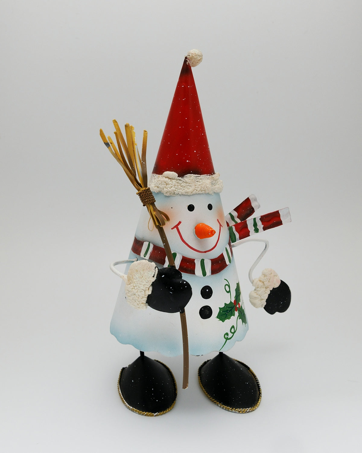 A festive snowman decoration with a broom