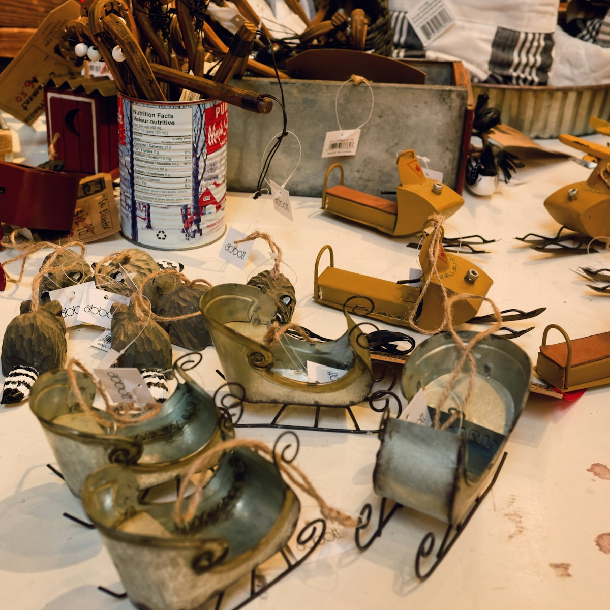 Small decorative sleds and ornaments on a table