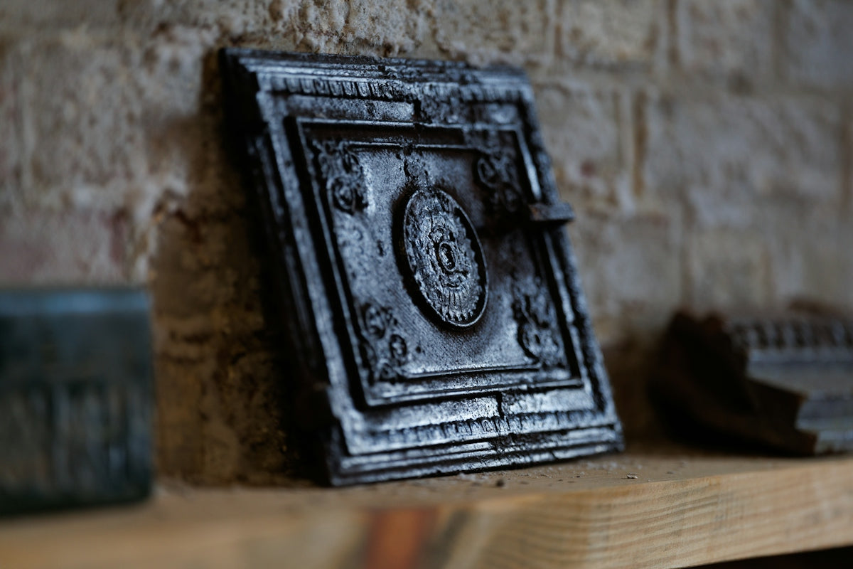 Antique ornate metal box on a wooden shelf