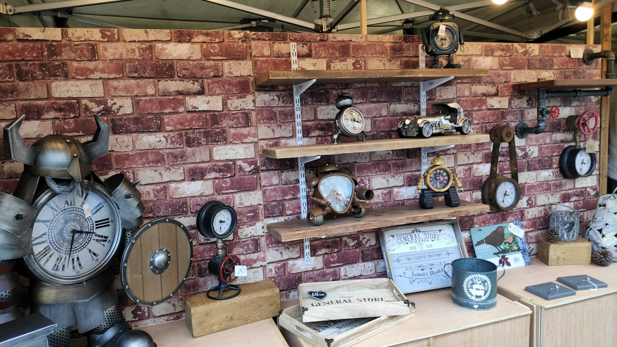 Antique clocks and decor displayed on wooden shelves