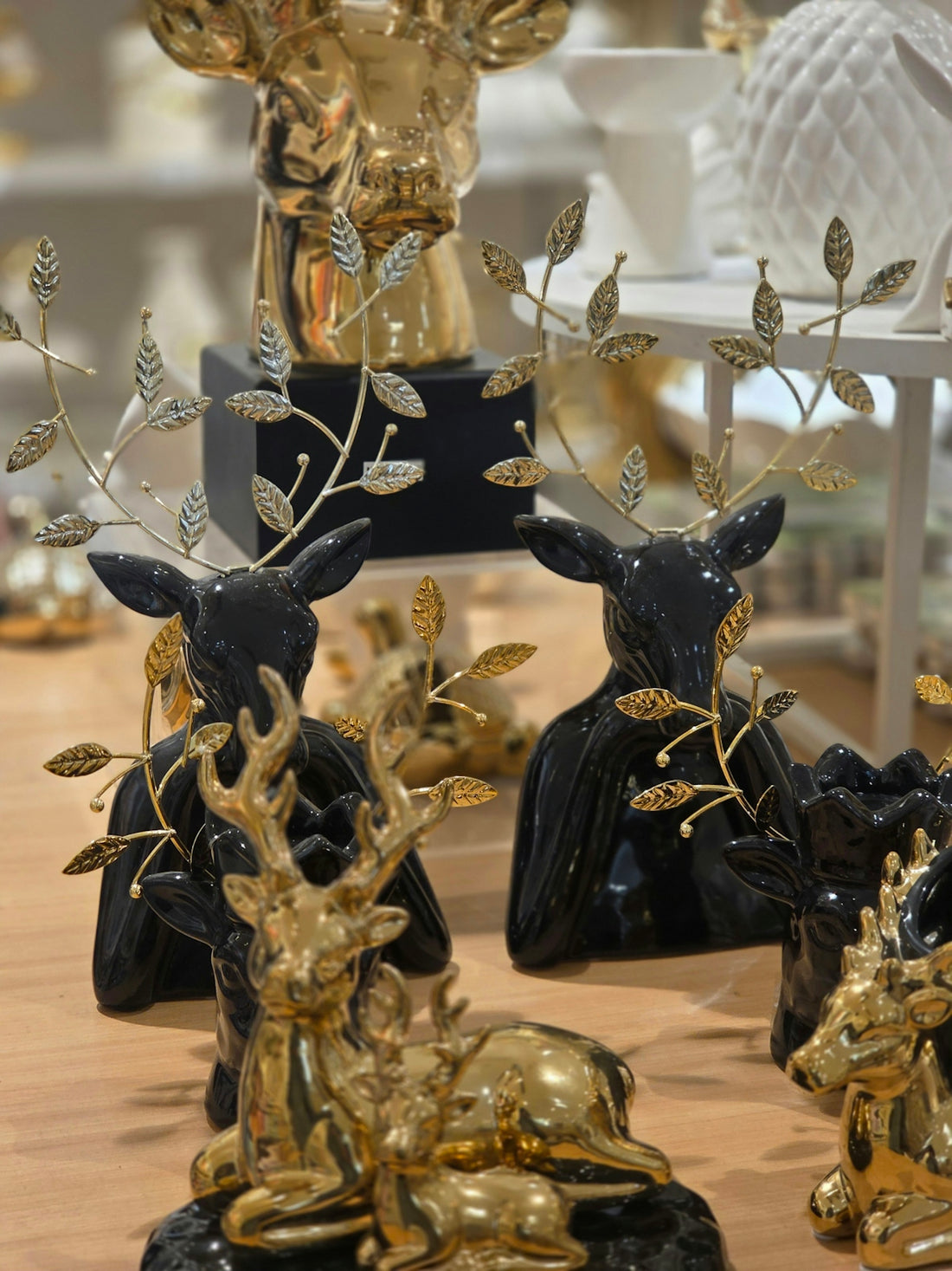 Several black and gold deer figurines with decorative antlers