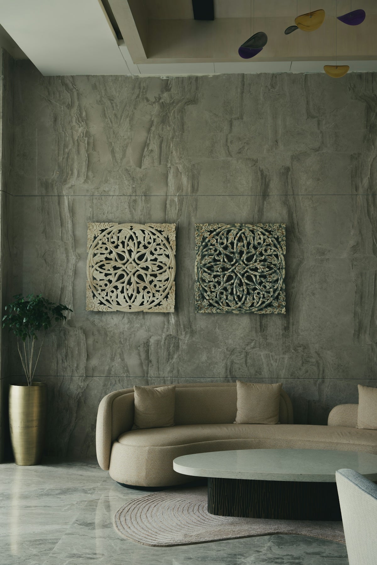 Modern living room with curved sofa and decorative wall panels
