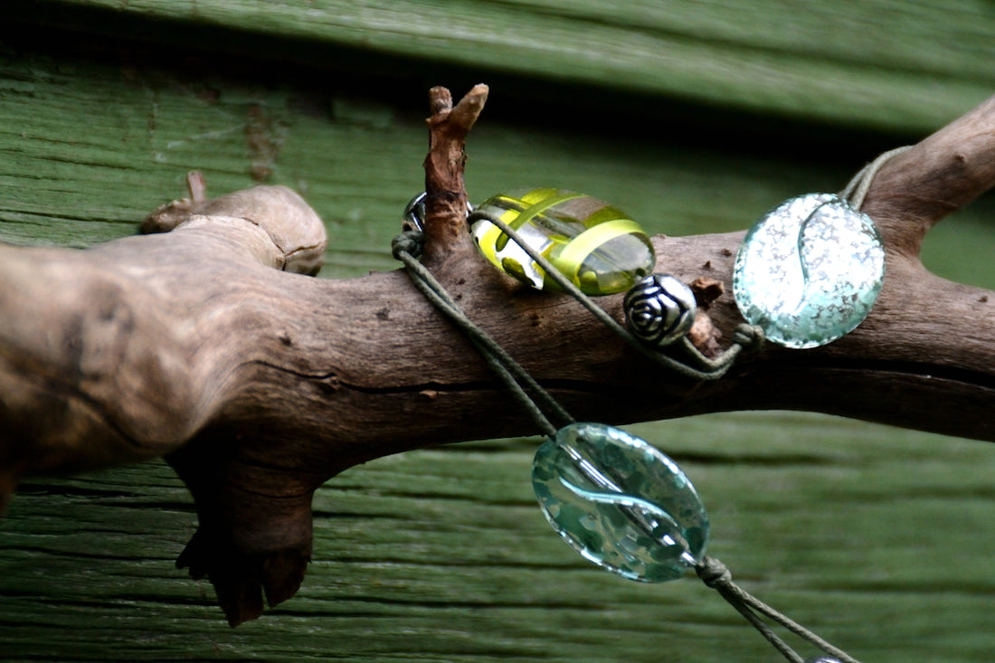 Glass beads jewelry hanging on a rustic wooden branch